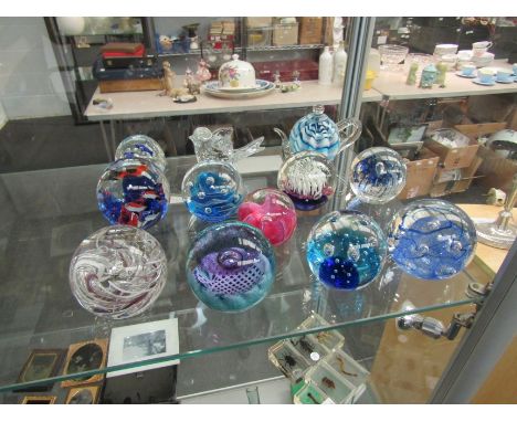 Twelve glass paperweights including one Caithness piece