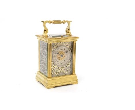 An ornate French brass carriage clock (possibly by Richard &amp; Co.), with silvered arabic dial, pierced ornate silvered fre