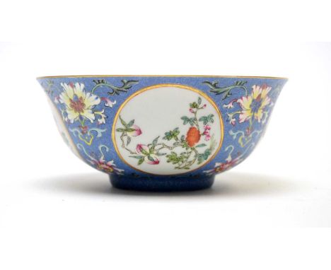 A Chinese Famille Rose sgraffito medallion bowl, the interior decorated in underglaze-blue with trees, rockwork and flowers, 