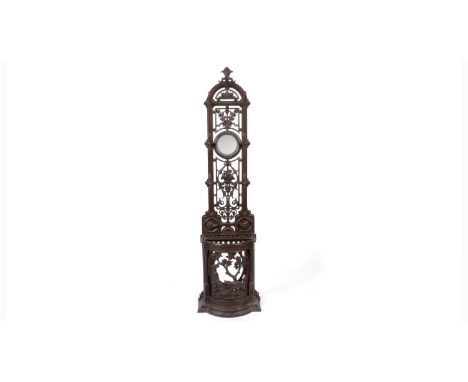 A Victorian Coalbrookdale style cast iron hall stand, the narrow back with a sunburst motif and foliate detailing above a mir