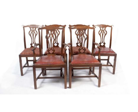 A set of six Georgian mahogany dining chairs in the Chippendale style having a pierced back splat, drop in seat pads raised o