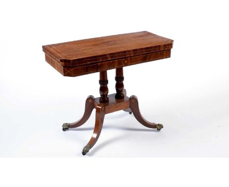 A Regency rosewood and satinwood banded card table, of canted rectangular form, the hinged swivel top opening to reveal a bai