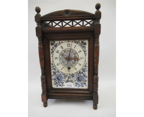Late Victorian Aesthetic movement mantel clock with a pierced gallery, the ceramic dial flanked by columns, with a single tra