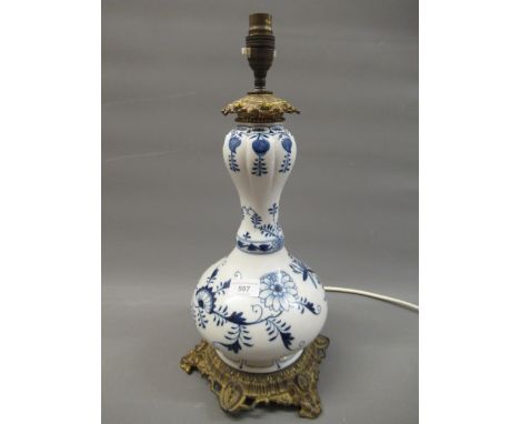 Continental blue and white porcelain and ormolu mounted baluster form lamp base, 14ins high excluding the lamp fitting 