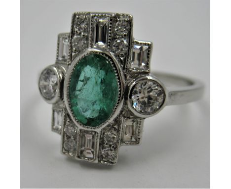 Platinum Art Deco style ring set with central oval emerald surrounded by diamonds, size P 