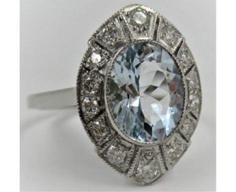 Platinum set Art Deco style ring set with a central oval aquamarine surrounded by diamonds, size O.5 