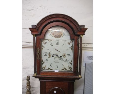 Early 19th Century mahogany longcase clock, the arched hood above an arched panel door, the enamel dial with Roman numerals, 