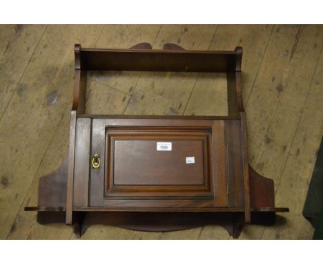 Late 19th Century walnut hanging wall bracket with panel door, the brass lock marked S&P and another glazed mahogany wall cab