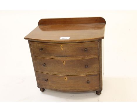 Miniature 19th Century mahogany bow fronted chest of drawers with knob handles and turned bun feet, together with 19th Centur