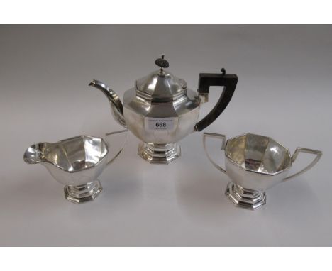 Chinese silver three piece tea service of European octagonal baluster pedestal design, marked ' Zeewo ', the teapot 9ins from