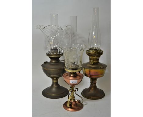 Brass oil lamp with a clear glass shade and chimney, another brass oil lamp minus shade and chimney and a small Art Nouveau c