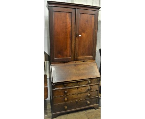 George III mahogany bureau bookcase, the moulded cornice above a pair of panelled doors and pair of candle slides, the base w