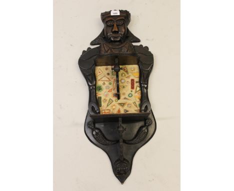Early 20th Century figural carved hardwood wall bracket inset with an embroidered panel, inscribed to the reverse ' Made by S
