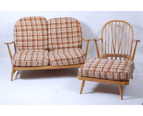 A 1960s Ercol light elm stickback lounge suite, comprising; a two-seater sofa, w.134cm, a single armchair, w.72cm, and a foot
