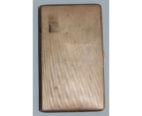 A large Art Deco silver pocket cigarette case, the engine turned exterior with plain rectangular cartouche upper left, gilt-w