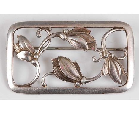 Georg Jensen - a sterling silver flower brooch, No.295, the round cornered rectangular panel having stylised and pierced flor