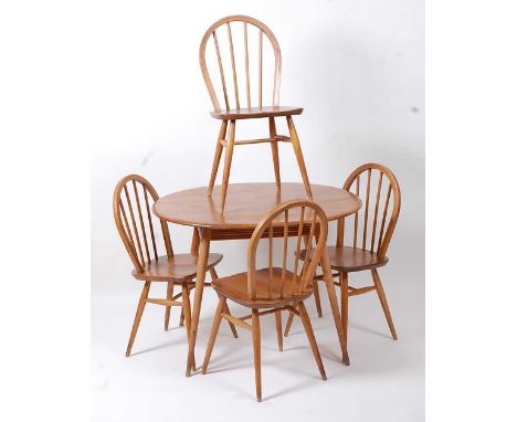 A 1960s Ercol light elm oval kitchen table, raised on turned tapering supports, h.72.5cm, length 99cm, d.89cm; together with 