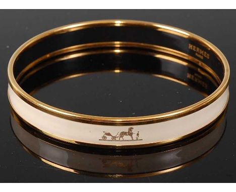 A Hermès gold plated and printed white enamel Grand Apparat bangle, dia.7cmCondition report: Original.Approx. 2mm scuffed are