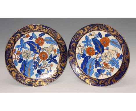 A pair of large 1930s ceramic chargers designed by Charlotte Rhead, pattern number 1420, retailed by Lawley's, of floral styl