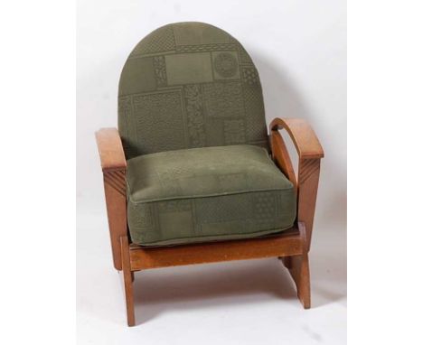 An Art Deco oak elbow chair, having green floral upholstered arched back, the panelled seat with removable cushion to curved 