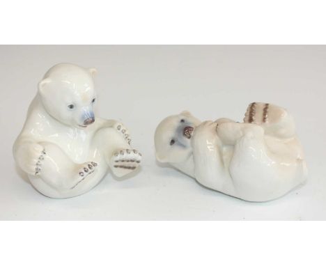 Two Royal Copenhagen porcelain figures of polar bear cubs, each in playful pose, printed backstamps, one numbered 536 and the