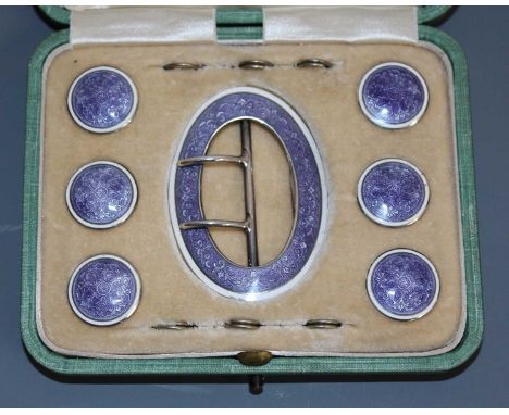 An early 20th century silver and floral guilloche enamelled cased belt buckle and button set, the oval buckle with typical hi