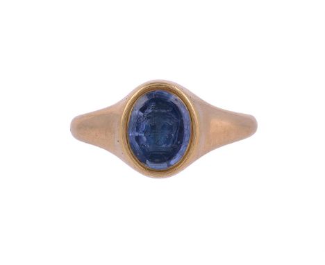 A VICTORIAN SAPPHIRE SIGNET RINGThe oval sapphire panel carved with an oak tree out of a ducal coronet, the trunk penetrated 