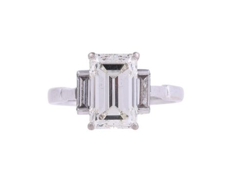 A SINGLE STONE DIAMOND RINGThe step cut diamond with canted corners weighing 3.11 carats, in a four claw setting, set above t