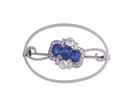 A SAPPHIRE AND DIAMOND CLUSTER BROOCHThe central oval cut sapphire and old cut, baguette cut and eight cut diamond cluster, a