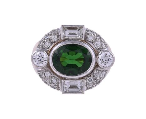 STEPHEN WEBSTER, A GREEN TOURMALINE AND DIAMOND DRESS RINGThe oval cut green tourmaline within a surround of brilliant cut an