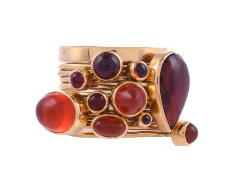 WENDY RAMSHAW CBE, AN 18 CARAT GOLD, GARNET AND FIRE OPAL ELEVEN RING STACK  LONDON 1987 The eleven stackable rings one a pol