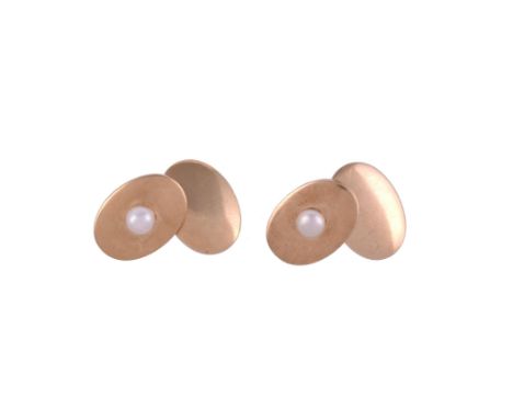 A PAIR OF EARLY 20TH CENTURY BOUTON PEARL CUFFLINKS The gold cufflinks with polished oval panels with a single bouton pearl, 