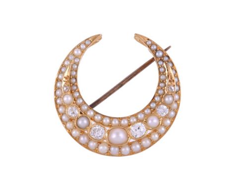 AN EDWARDIAN DIAMOND AND HALF PEARL CRESCENT BROOCH CIRCA 1910The circular gold crescent set with graduated half pearls and o