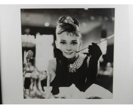 A facsimile print of Audrey Hepburn in Breakfast at Tiffany's. H.33cm W.33cm