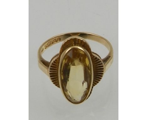 A 9 carat yellow gold and citrine ring, set oval cut stone.