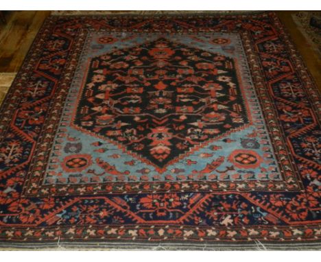 A light blue Turkish Kula rug, the centre with hexagonal medallion and geometric design, within many borders, fringed. L.200c