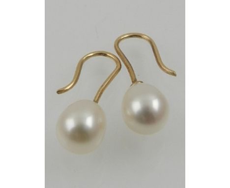 A pair of yellow gold and pearl drop earrings. 