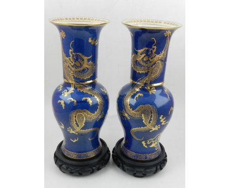 A pair of Carltonware lustre vases, decorated with gilt dragons on a blue ground, having an everted rim. H.28cm