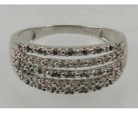 A 9 carat white gold and black and white diamond five band ring. 