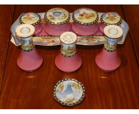 An early 20th century dressing table service, transfer decorated with birds on a pink ground, comprising a rectangular tray, 