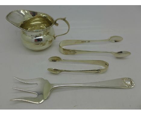 Two pairs of silver sugar bows, a silver jug and a silver bread fork, total weight 95g