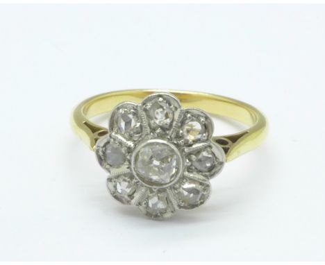 A yellow metal and diamond flower ring, 3.1g, K