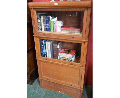 A Globe Wernicke type bookcase, rectangular top above three horizontally hinged and retractable doors, the upper two glazed, 