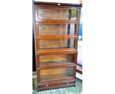A Globe Wernicke bookcase, rounded cornice above five glazed horizontally hinged and retractable doors and a long drawer, 181