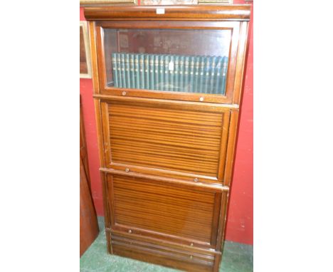 A Globe Wernicke type bookcase, rectangular top above three horizontally hinged and retractable doors, the upper glazed, and 