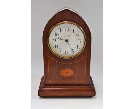 An Edwardian mahogany inlaid arched mantel timepiece, white enamel dial, Arabic numerals, W Bruford and Son, Eastbourne and E