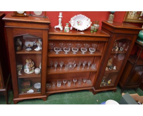 A Victorian mahogany low bookcase, moulded top with sunken centre above open shelves, flanked by a pair of glazed doors, skir