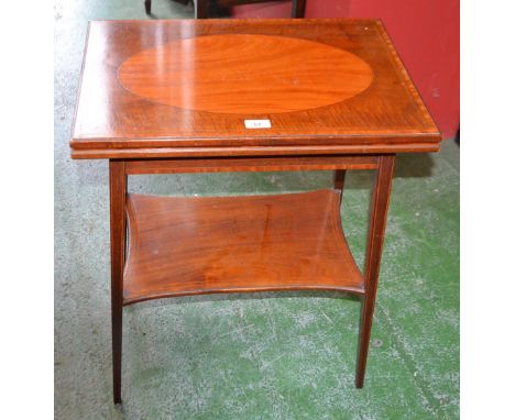 An Edwardian mahogany patience/card table, hinged rectangular top enclosing a baize lined playing surface, incurved rectangul