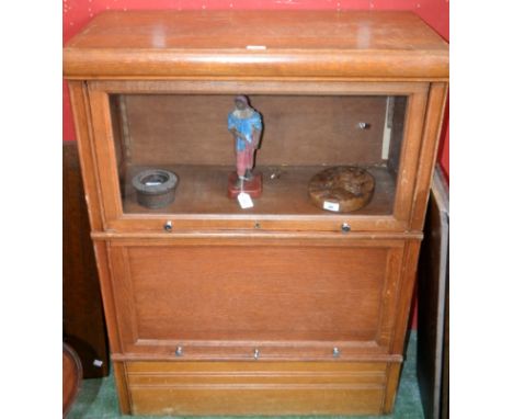 A Globe Wernicke type bookcase, rectangular top above two horizontally hinged and retractable doors, the upper glazed, 109.5c