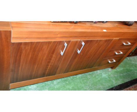 A contemporary teak effect sideboard, rectangular top above three short drawers and a pair of cupboard doors enclosing a shel